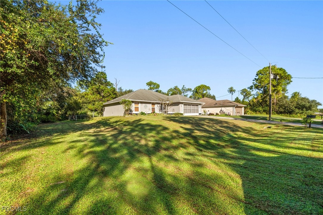 2005 Mc Arthur Avenue Alva, FL 33920 - Photo 3 of 32 a view of a big yard with table and chairs