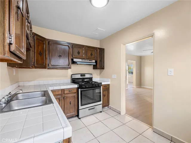 a kitchen with stainless steel appliances granite countertop a stove and a sink