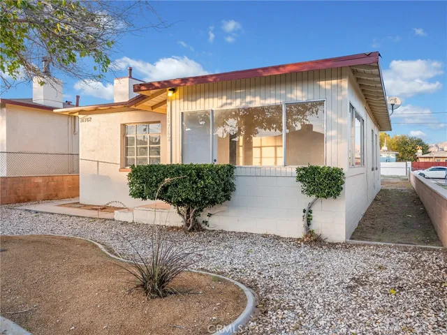 a view of a house with a yard and a street
