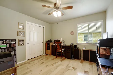 a view of a workspace with furniture and a window