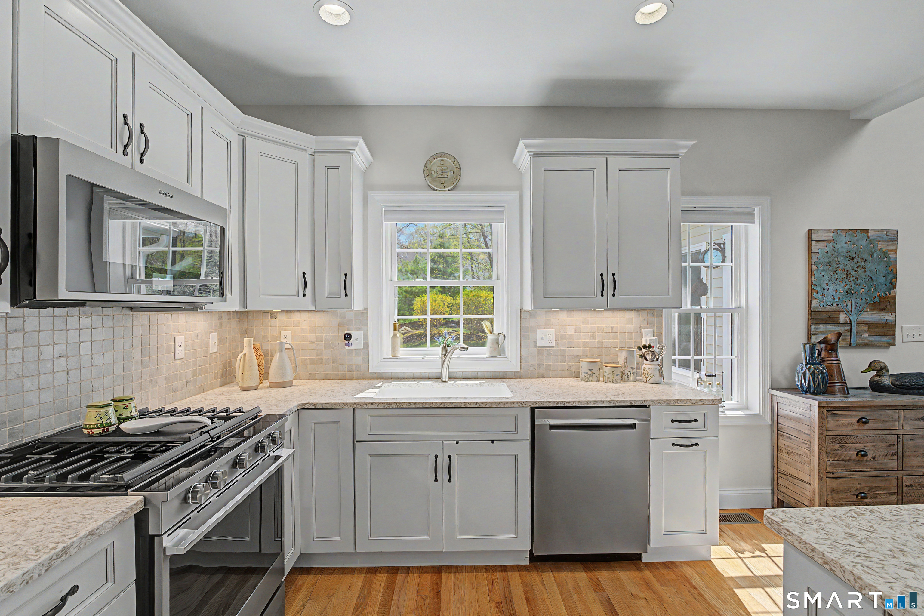 211 Meadowbrook Road, Unit 211 Oxford, CT 06478 - Photo 12 of 38 Thoughtfully designed kitchen with abundant cabinetry, modern stainless steel appliances, and a perfectly placed window that brings in natural light and views of the surrounding greenery.
