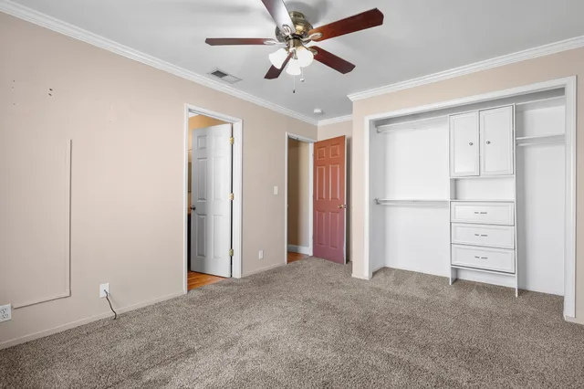 a view of an empty room with a ceiling fan