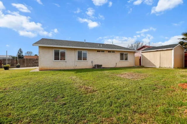 a view of house with backyard