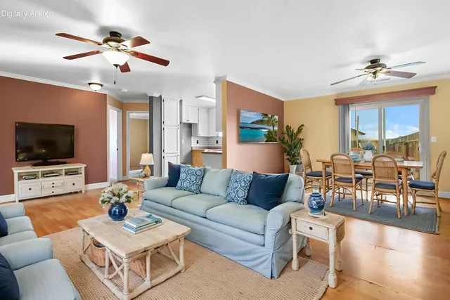 a living room with furniture a flat screen tv and a window