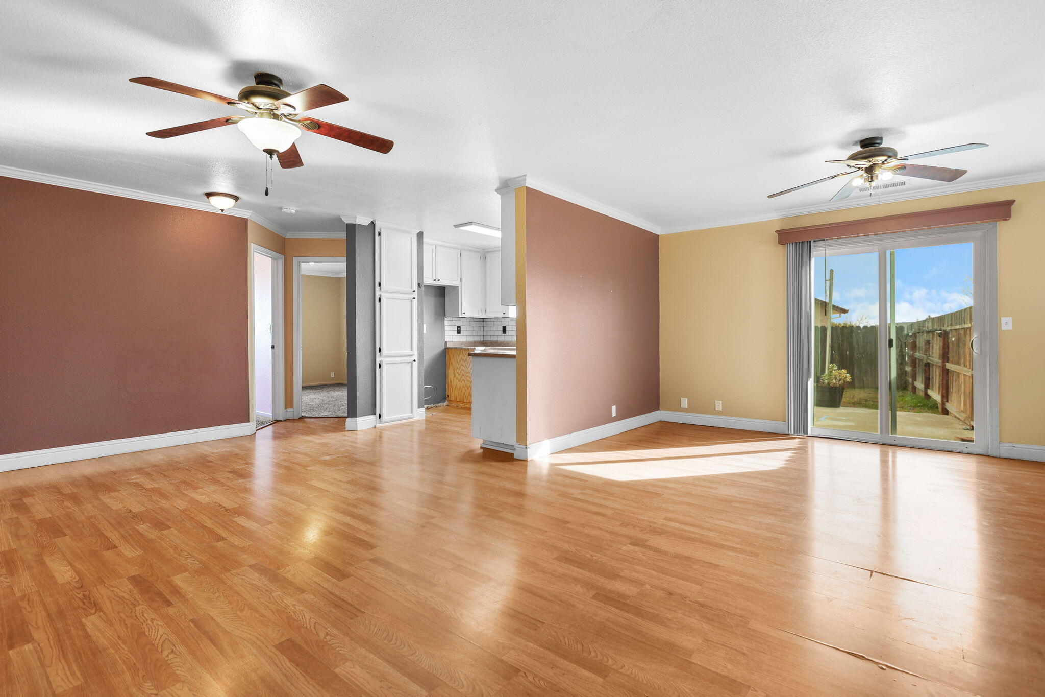 2180 Gentry Way Red Bluff, CA 96080 - Photo 3 of 27 a view of an empty room with a window and wooden floor