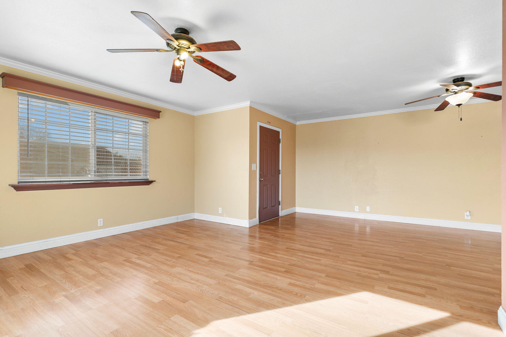 2180 Gentry Way Red Bluff, CA 96080 - Photo 4 of 27 a view of an empty room with a window and wooden floor