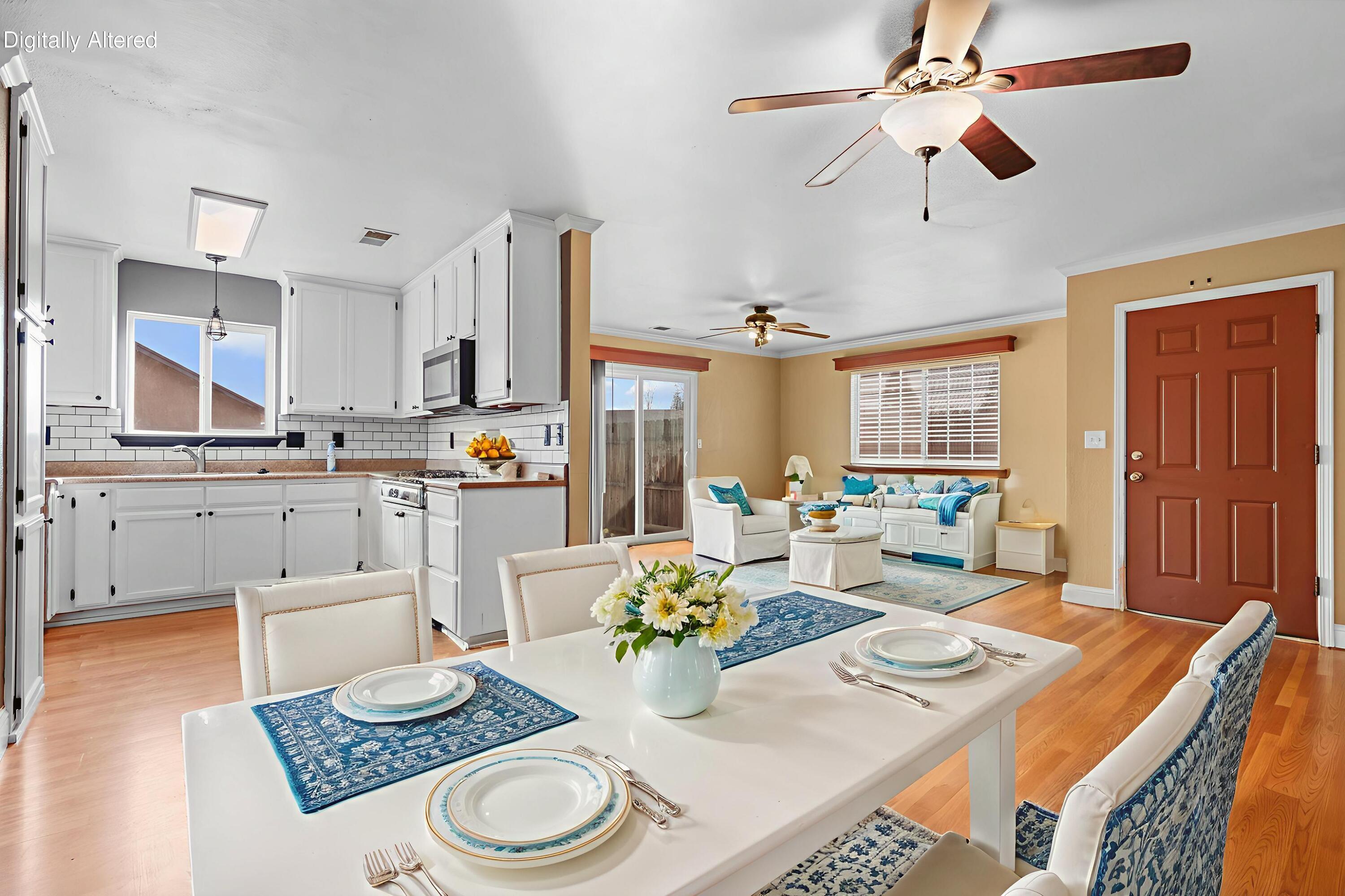 2180 Gentry Way Red Bluff, CA 96080 - Photo 5 of 27 a kitchen with a table chairs and white cabinets