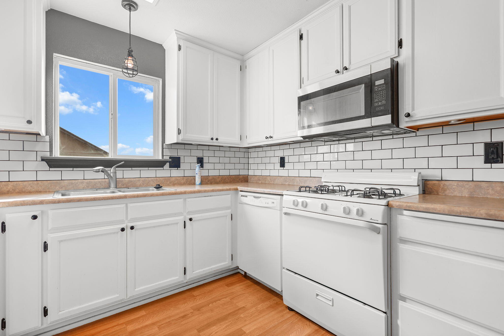 2180 Gentry Way Red Bluff, CA 96080 - Photo 7 of 27 a kitchen with cabinets appliances a sink and a counter top space