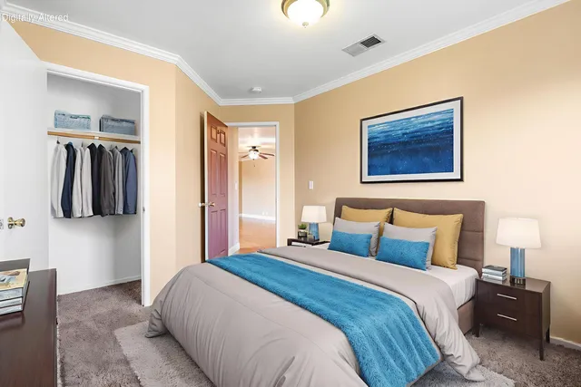 a bedroom with a bed and a wall painting