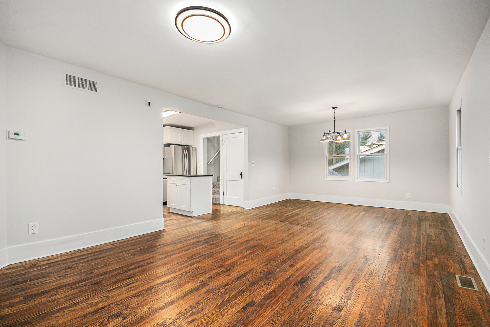 247 North West Road Lombard, IL 60148 - Photo 4 of 25 a view of empty room with wooden floor and fan
