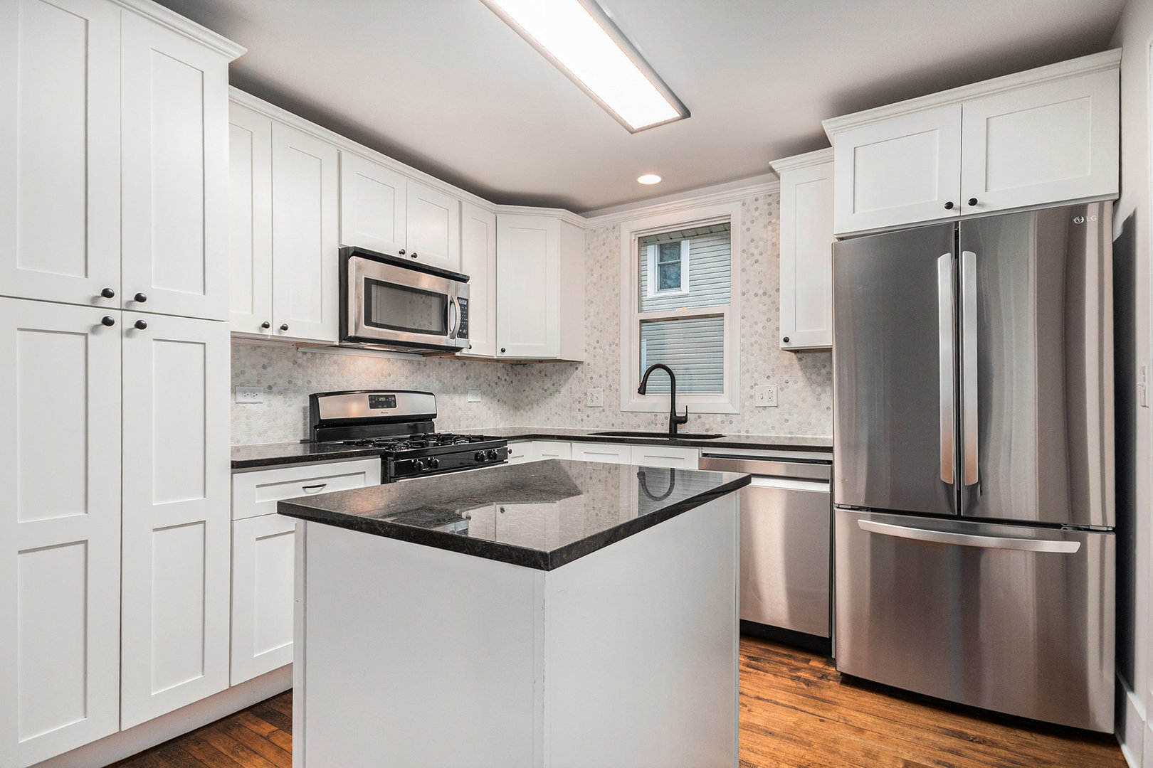 247 North West Road Lombard, IL 60148 - Photo 6 of 25 a kitchen with granite countertop a refrigerator stove and microwave
