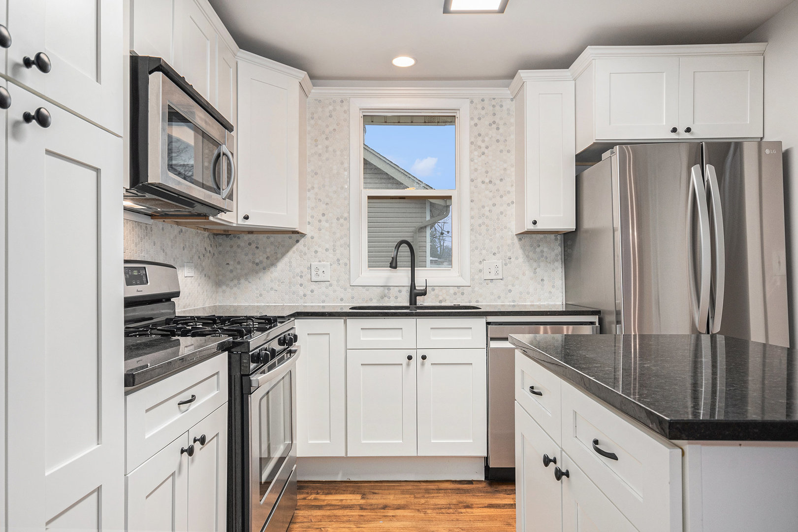247 North West Road Lombard, IL 60148 - Photo 7 of 25 a kitchen with stainless steel appliances granite countertop a stove a refrigerator and a sink