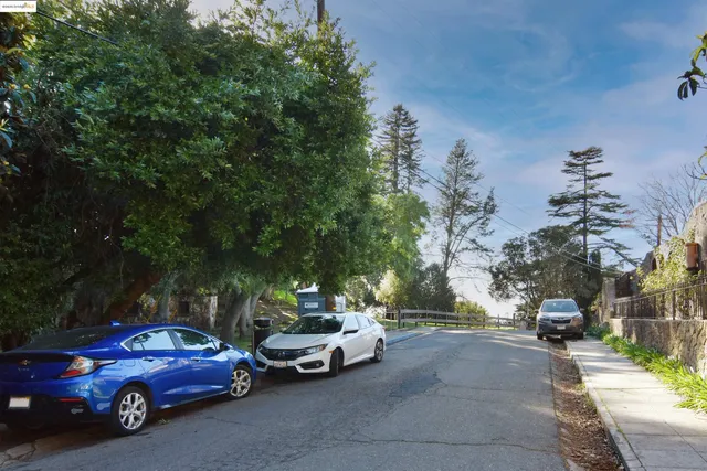 a view of a cars parked on the side of a street