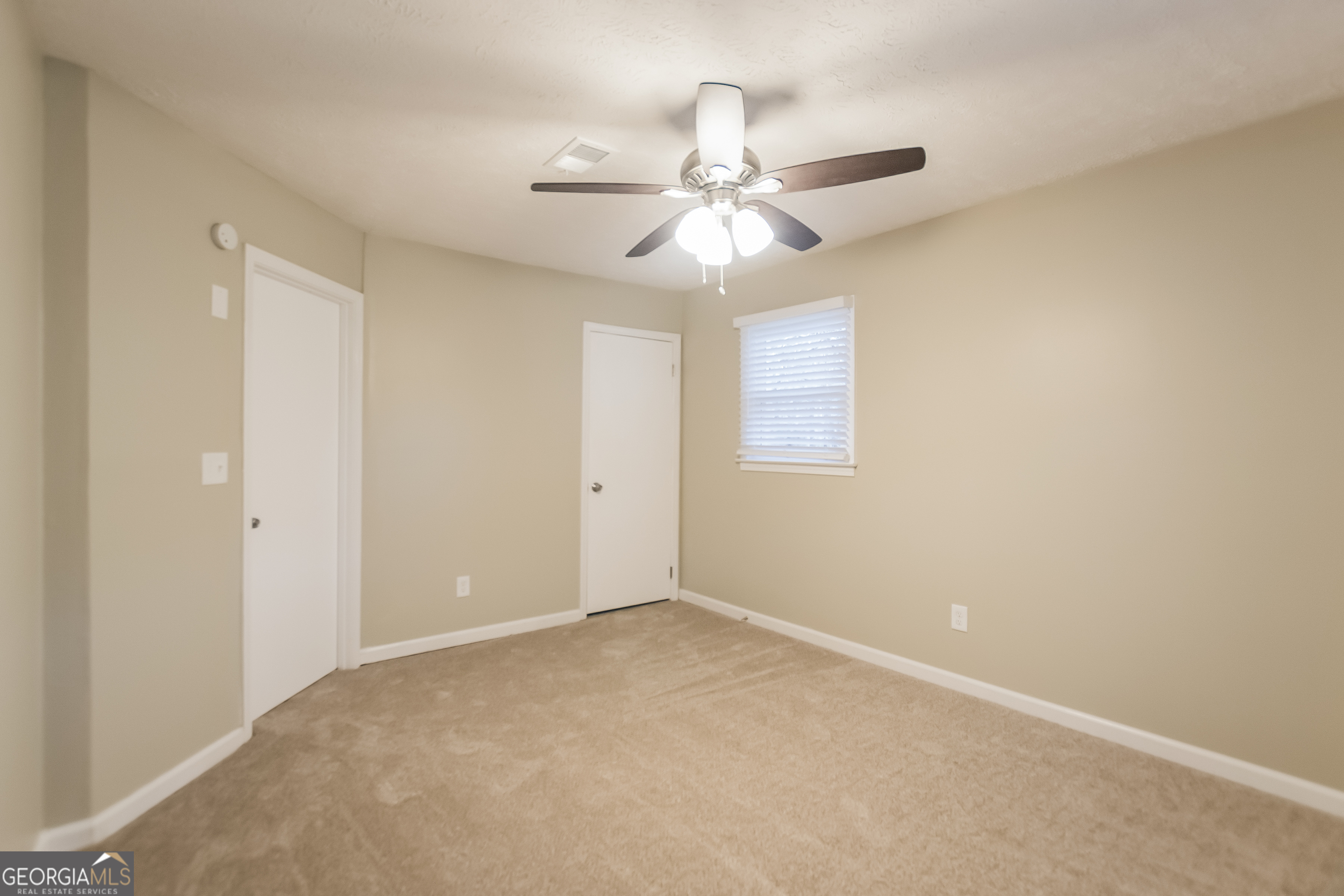 3250 Ridgecrest Drive Powder Springs, GA 30127 - Photo 11 of 15 an empty room with windows and fan