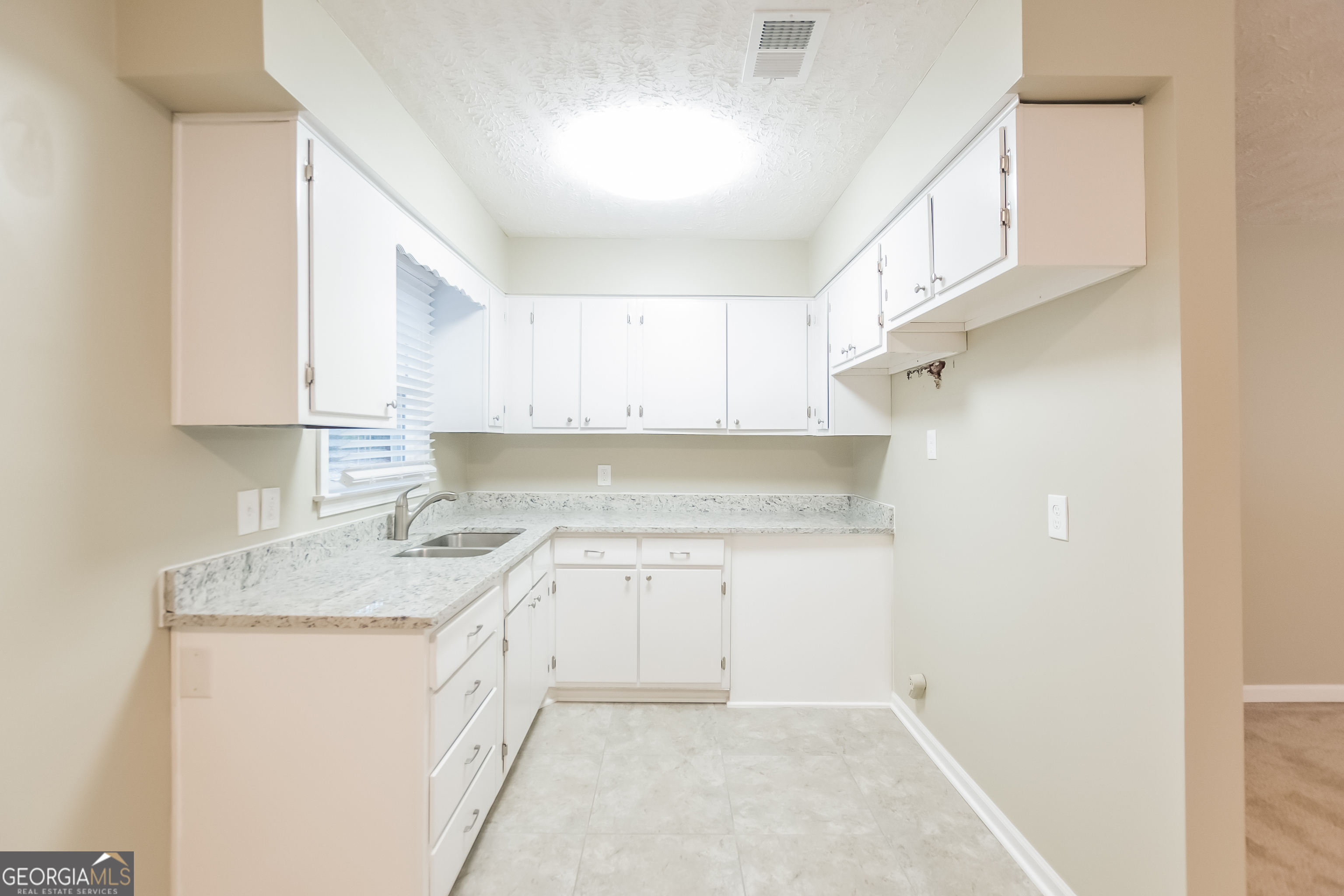 3250 Ridgecrest Drive Powder Springs, GA 30127 - Photo 6 of 15 a kitchen with a sink stove and cabinets
