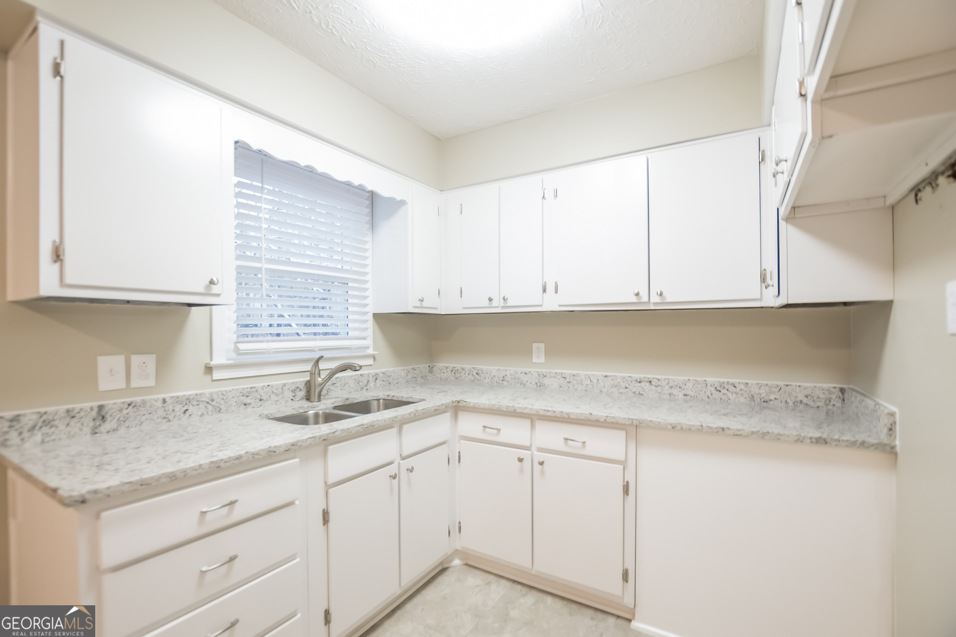 3250 Ridgecrest Drive Powder Springs, GA 30127 - Photo 7 of 15 a kitchen with granite countertop white cabinets and a sink