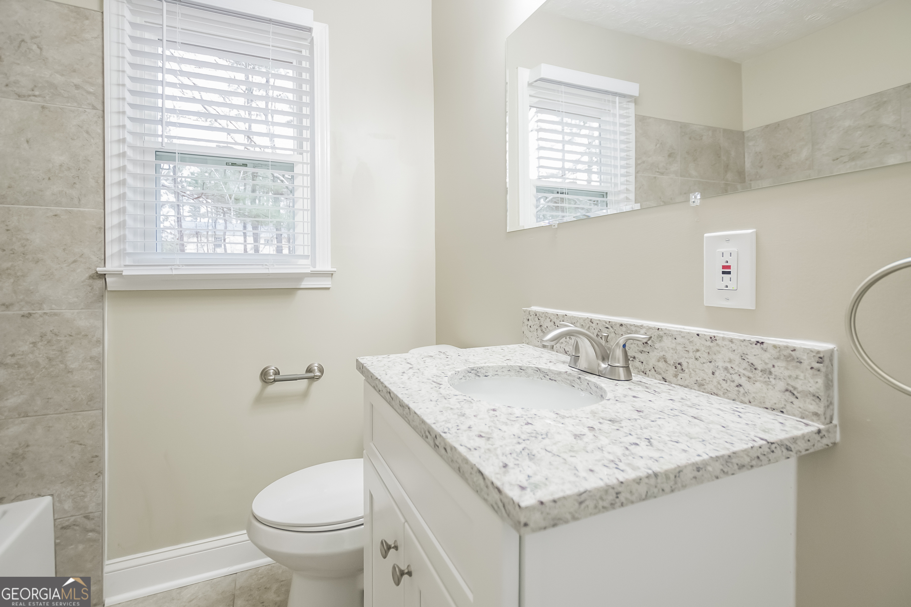 3250 Ridgecrest Drive Powder Springs, GA 30127 - Photo 10 of 15 a bathroom with a granite countertop sink and a toilet