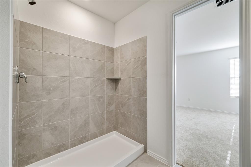 2809 Ozark Circle Little Elm, TX 75068 - Photo 24 of 28 a bathroom with a bathtub