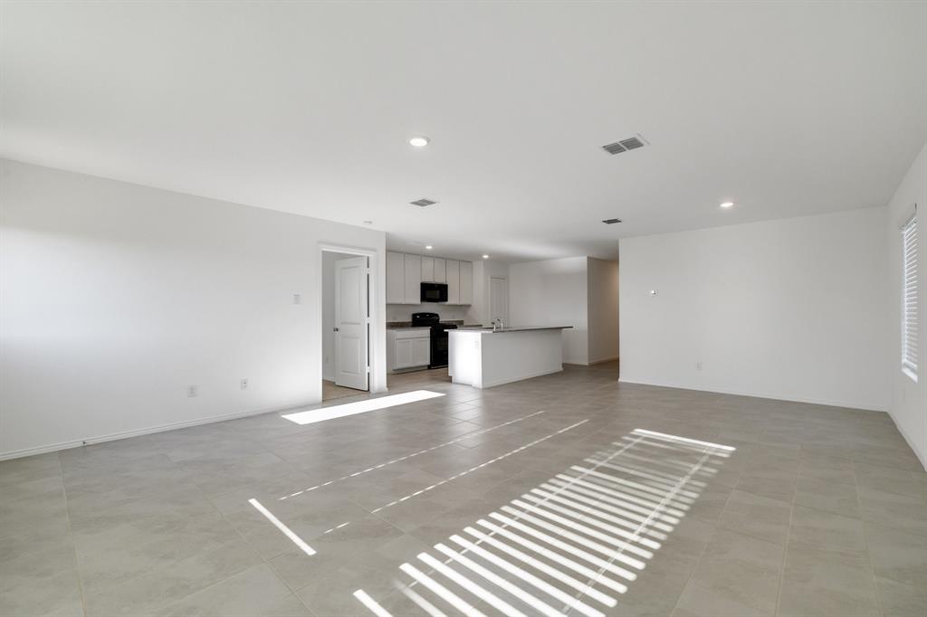 2809 Ozark Circle Little Elm, TX 75068 - Photo 3 of 28 a view of kitchen with kitchen island wooden cabinets and refrigerator