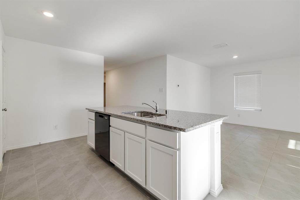 2809 Ozark Circle Little Elm, TX 75068 - Photo 9 of 28 a kitchen that has a sink and a stove