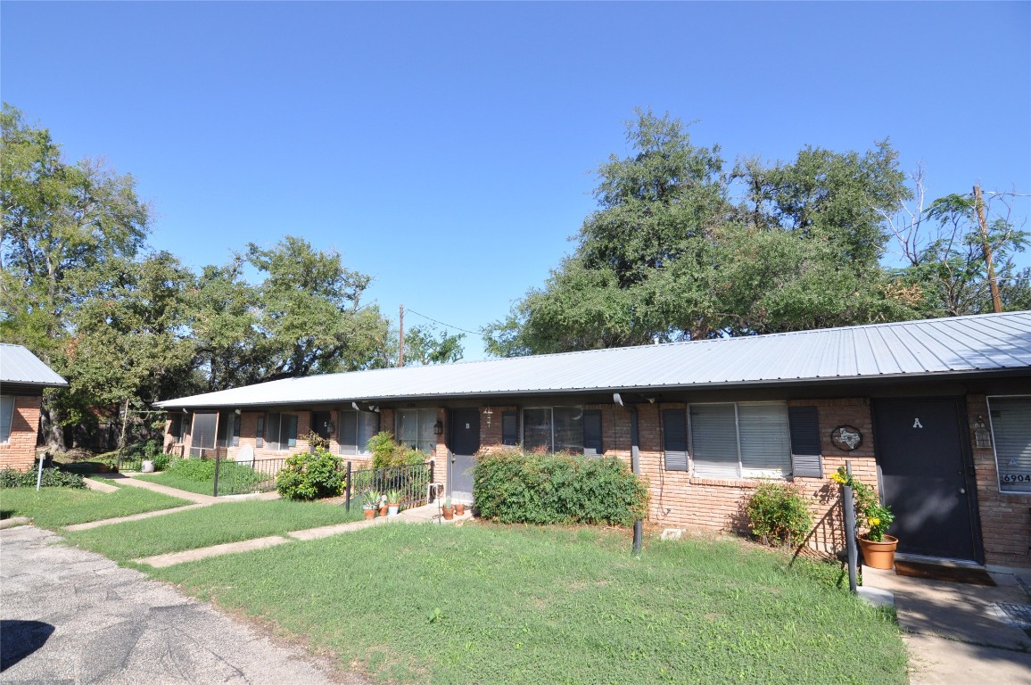 6904 Circle S Road, Unit C Austin, TX 78745 - Photo 1 of 1 a front view of a house with a yard and garage
