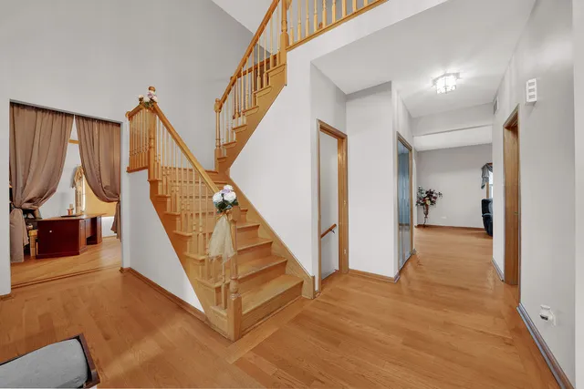 a view of entryway and hall with wooden floor