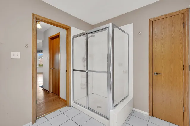 a view of entryway with white walls and cabinet