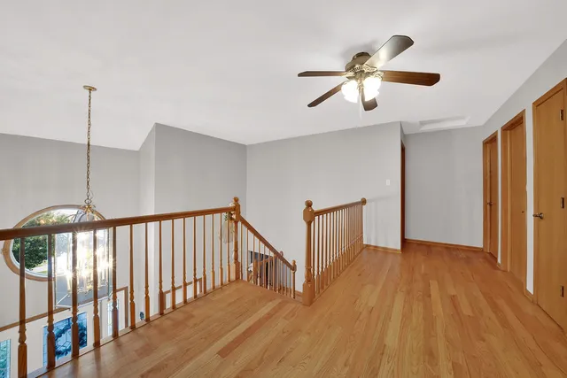 a view of a room with wooden floor and staircase