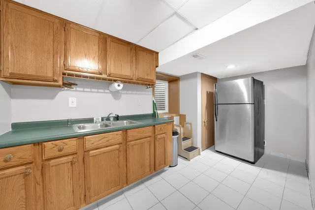 a kitchen with stainless steel appliances granite countertop a refrigerator and a sink