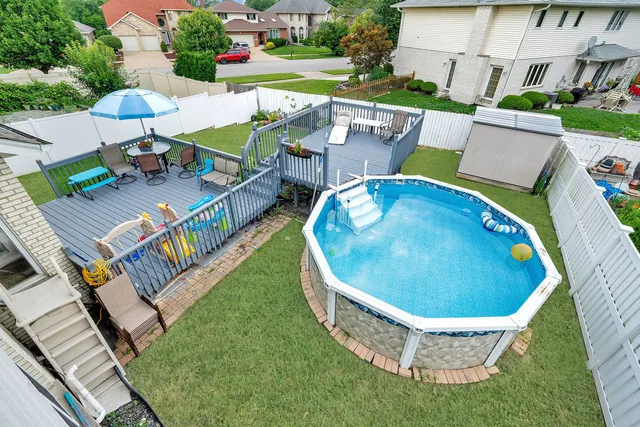 swimming pool view with a seating space
