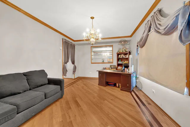 a living room with furniture a dining table and a chandelier