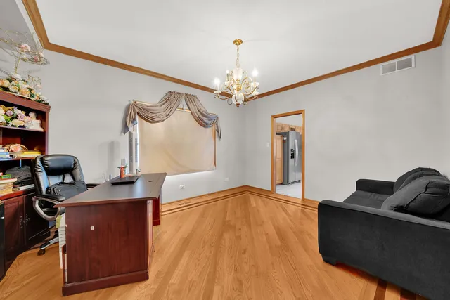 a view of a livingroom with workspace and a window