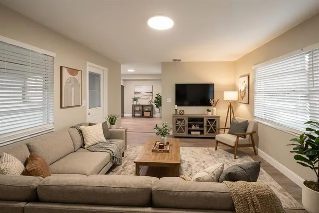a living room with furniture and a flat screen tv