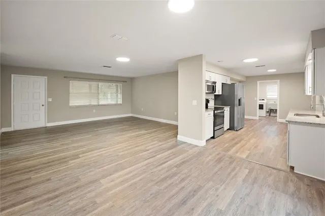 a view of a kitchen with a sink and a refrigerator