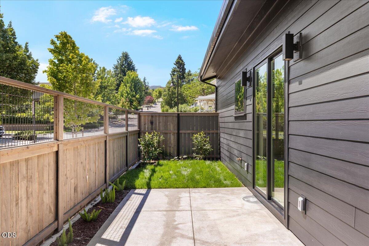 391 Clinton Street Ashland, OR 97520 - Photo 12 of 41 a view of a backyard with wooden fence