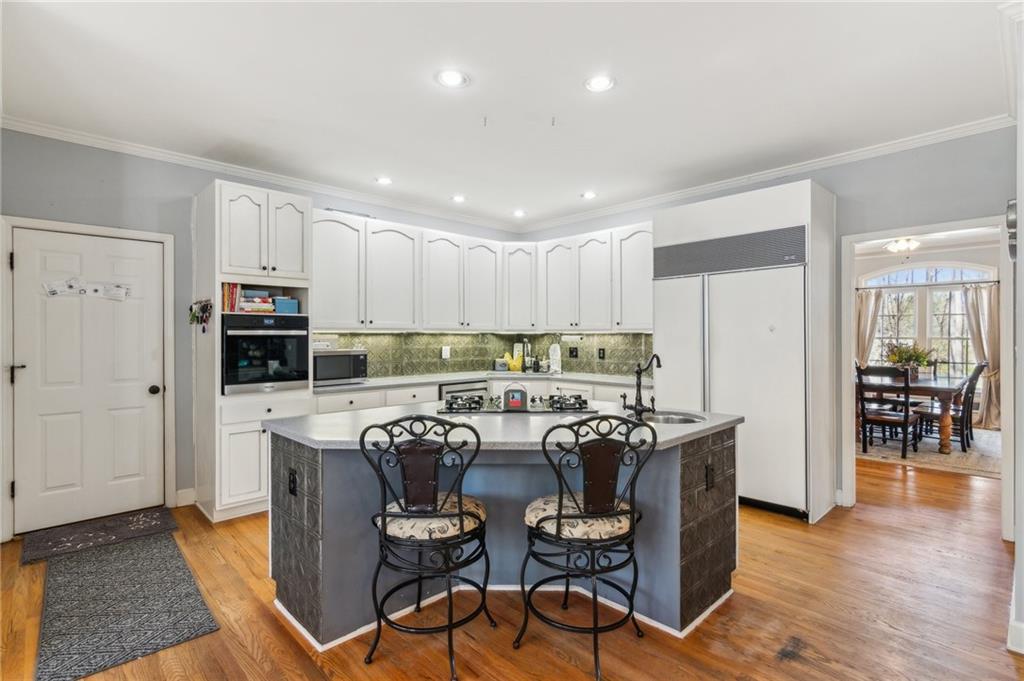 5388 Frazer Road Buford, GA 30518 - Photo 16 of 83 a view of a dining room with furniture and wooden floor