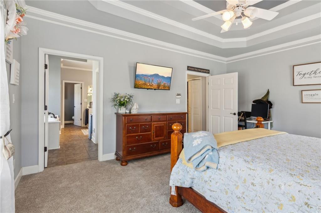 5388 Frazer Road Buford, GA 30518 - Photo 21 of 83 a bedroom with a bed and a chandelier