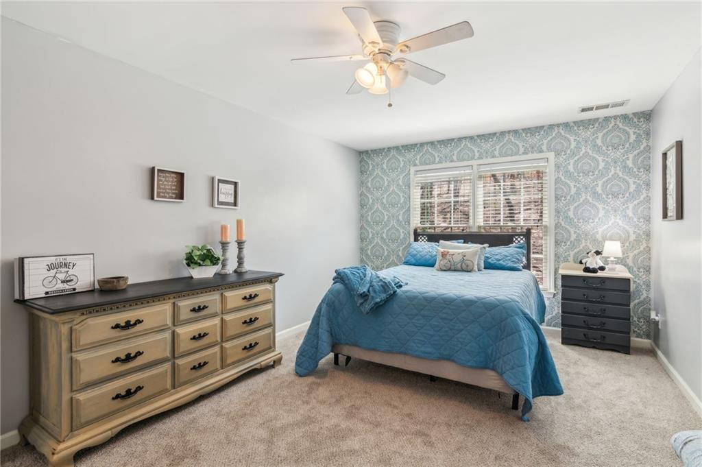 5388 Frazer Road Buford, GA 30518 - Photo 27 of 83 a bedroom with a bed and a dresser