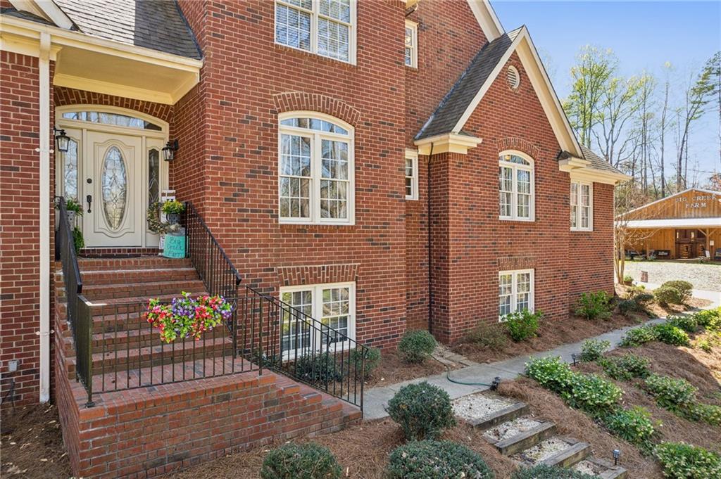 5388 Frazer Road Buford, GA 30518 - Photo 3 of 83 a front view of a house with a garden