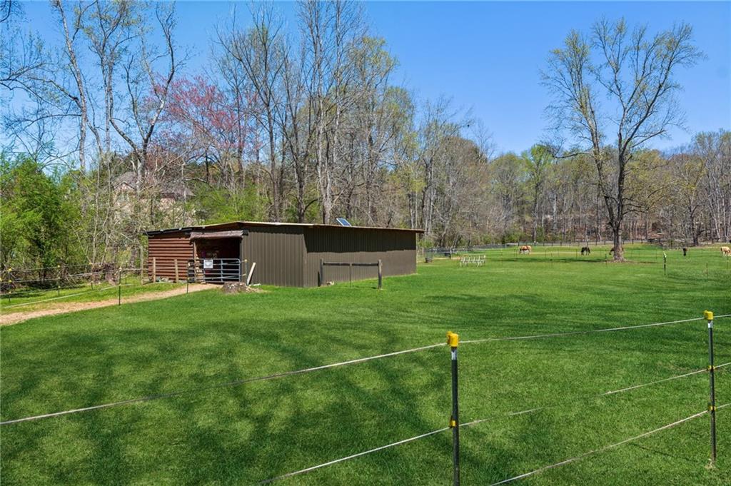 5388 Frazer Road Buford, GA 30518 - Photo 45 of 83 a backyard of a house with table and chairs