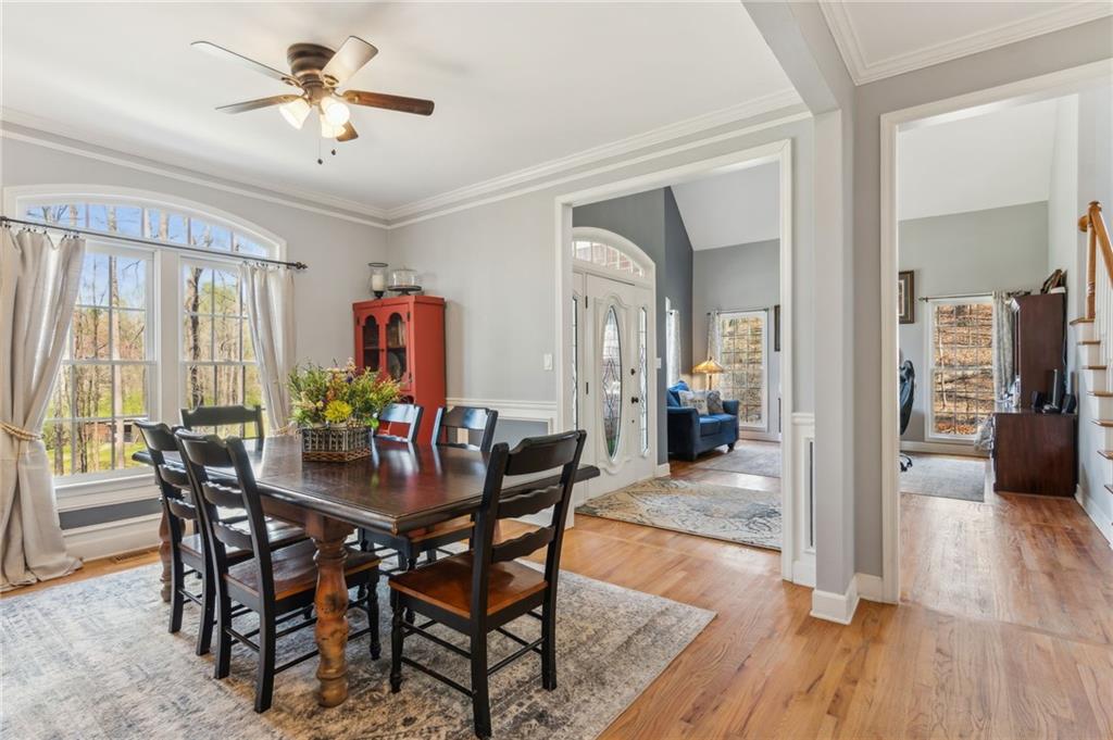 5388 Frazer Road Buford, GA 30518 - Photo 8 of 83 a view of a dining room with furniture and wooden floor