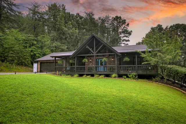 a front view of a house with yard and green space