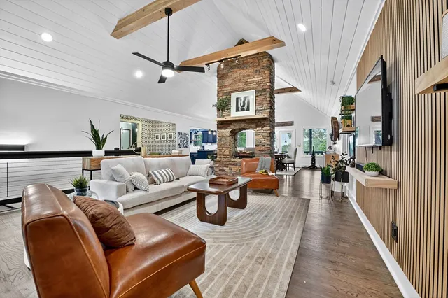 a dining room with furniture a chandelier and wooden floor