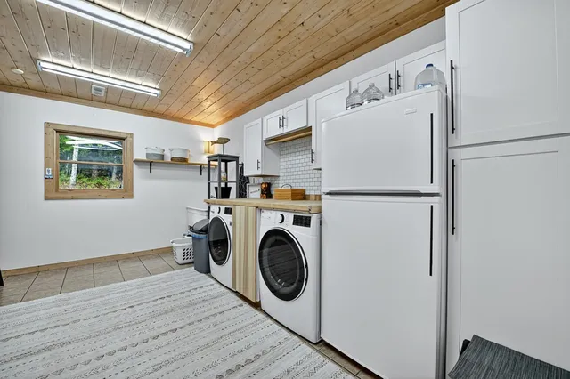 a bedroom with a bed window and a flat screen tv