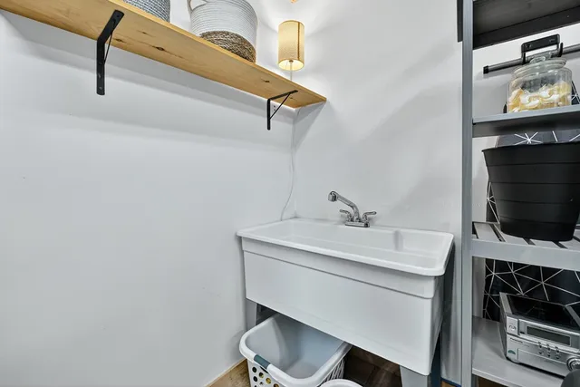 a bathroom with a sink mirror and toilet