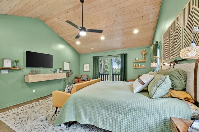 a bedroom with a bed and a flat screen tv