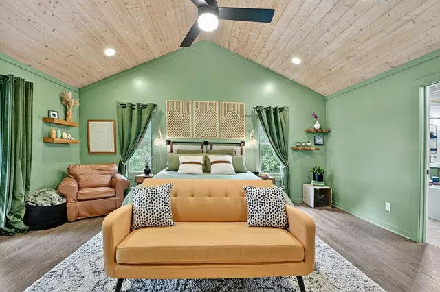 a balcony with chairs and wooden fence