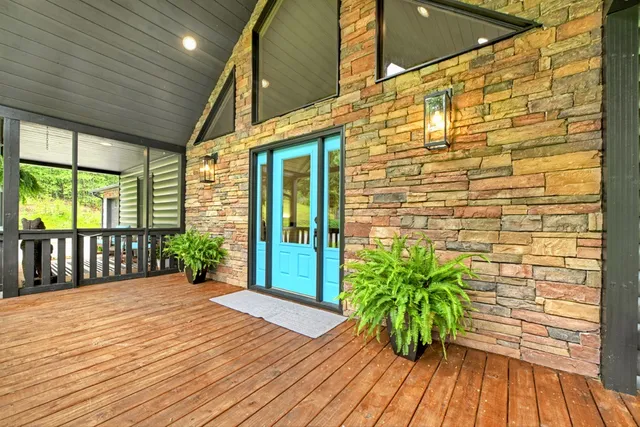 a living room with furniture a ceiling fan and a rug