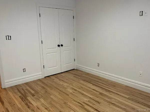 a view of room with wooden floor