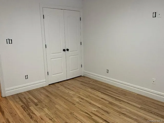 a view of room with wooden floor